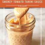 smoky tahini sauce in a glass jar with a spoon dipping out a portion with pinterest text overlay