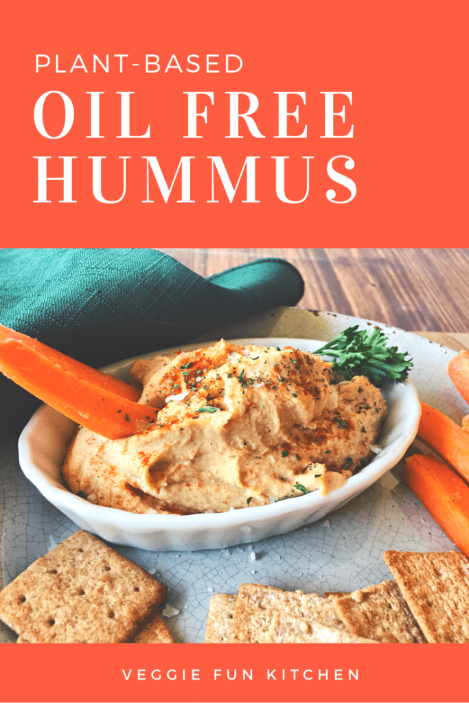 Oil-free hummus in white dish with carrot stick with text overylay