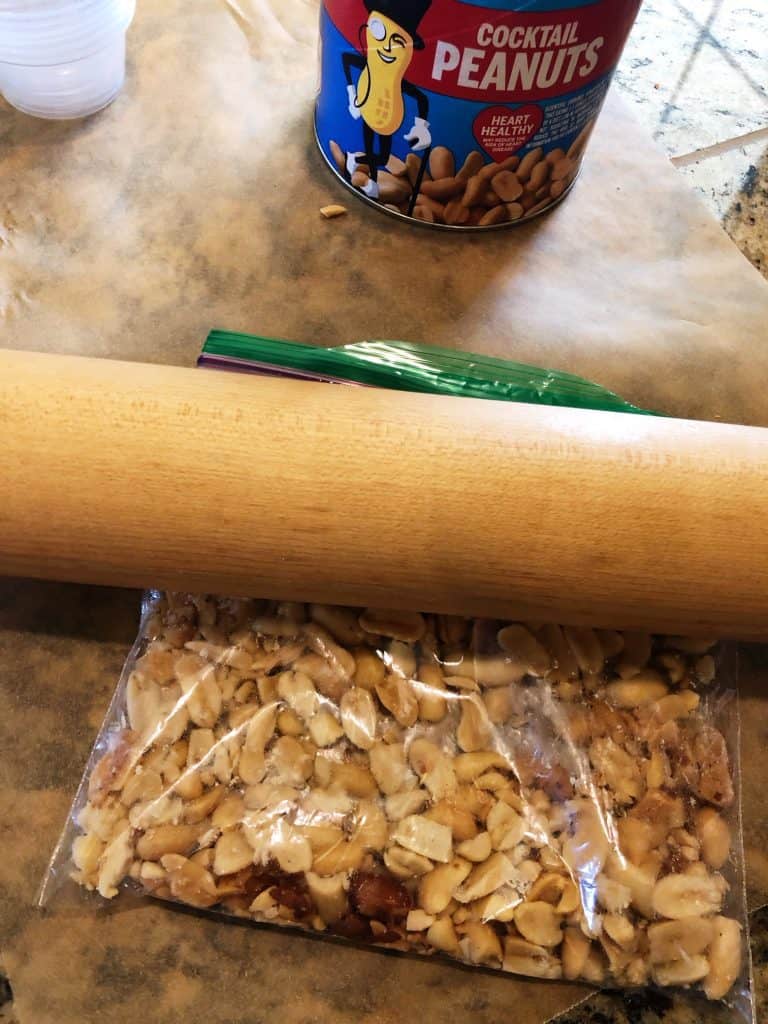 rolling pin crushing peanuts
