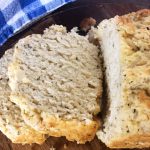 two slices of garlic herb beer bread with blue checkered napkin