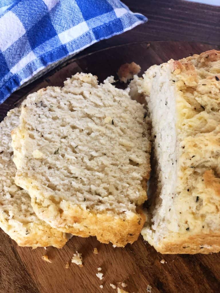 two slices of garlic herb beer bread with blue checkered napkin