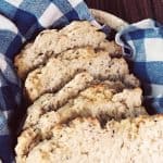 five slices of garlic herb beer bread in basket with blue checkered cloth