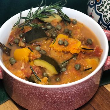 slow cooker butternut squash ratatouille in red bowl with green napkin