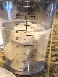 butter in measuring cup and water