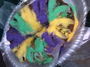 king cake with wax paper around the edges