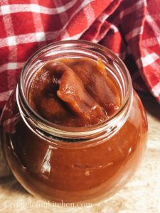 bbq sauce in a jar with red checked cloth