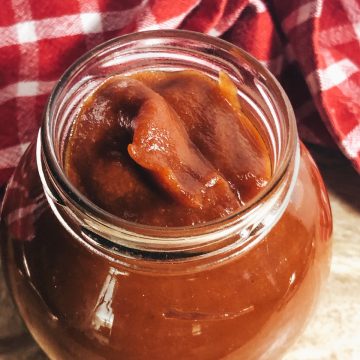 bbq sauce in a jar with red checked cloth