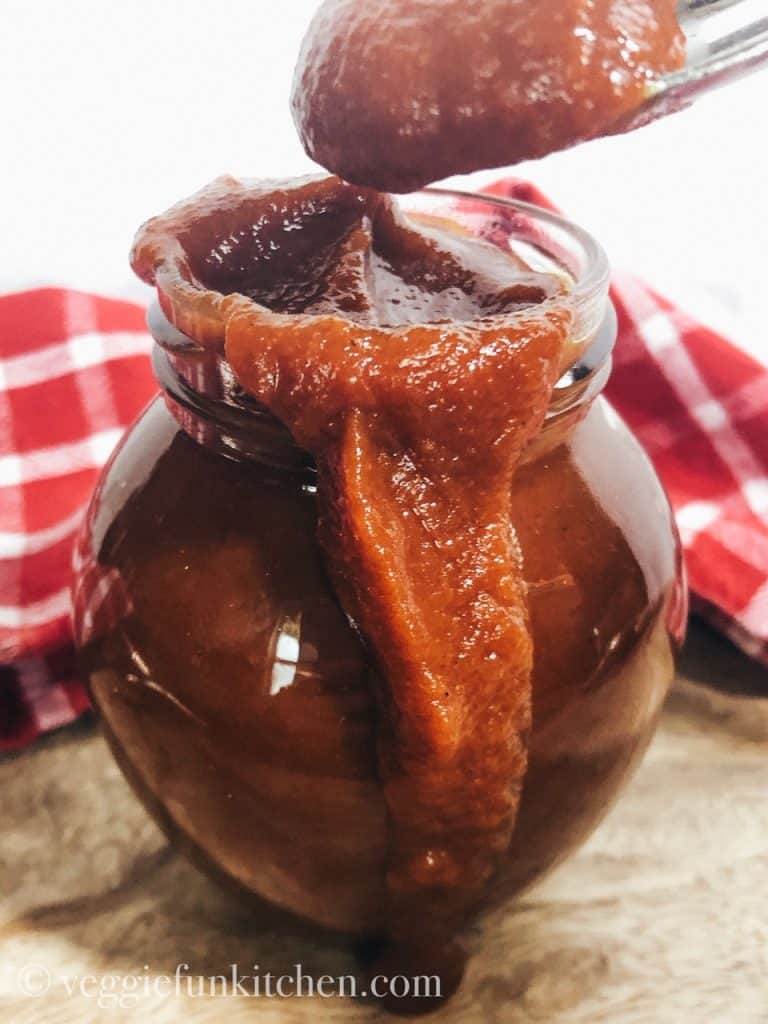 bbq sauce in a jar with a spoon
