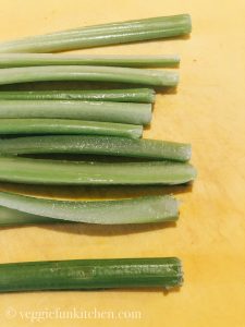 celery strips on a yellow cutting board