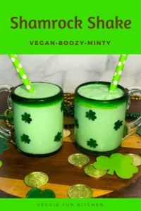 two shamrock shakes in glasses with green polkadot straws