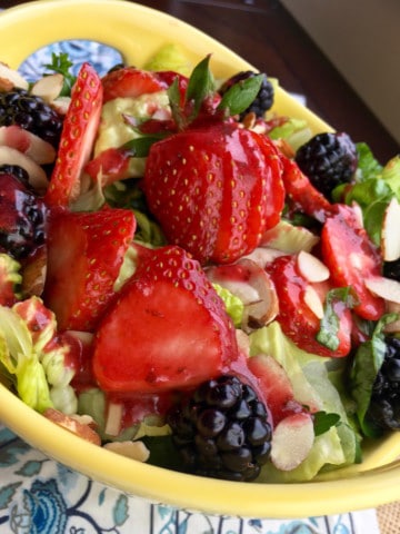 berry salad with almonds in yellow dish