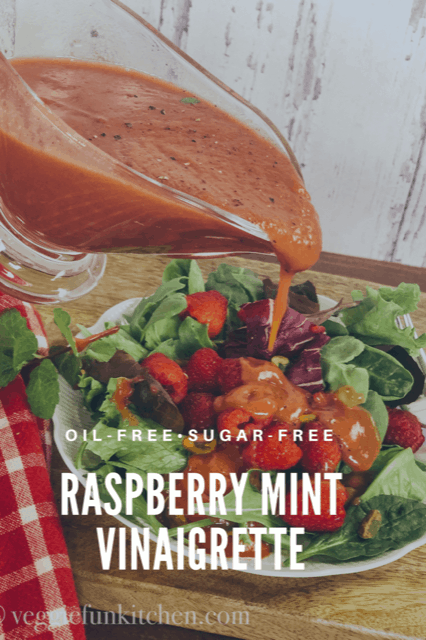 raspberry mint vinaigrette being poured onto berry salad