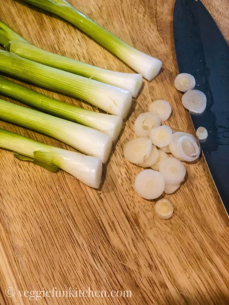 green onions sliced on a cutting board