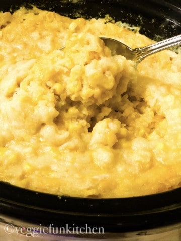 vegan corn casserole in crockpot spooned out