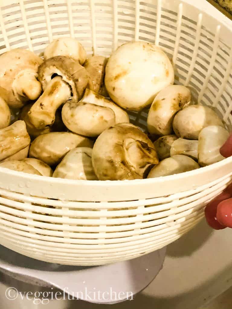 mushrooms washing in draining basket