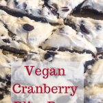 vegan cranberry bliss bars cut up on parchment with text overlay