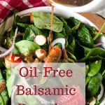 balsamic oil-free dressing pouring on spinach salad out of white container with text overlay