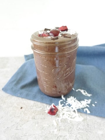black forest cake smoothie in jar with blue napkin