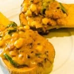 Twobutternut squash half stuffed with curried chickpeas cooked