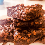 stacked fudge brownies with text overlay