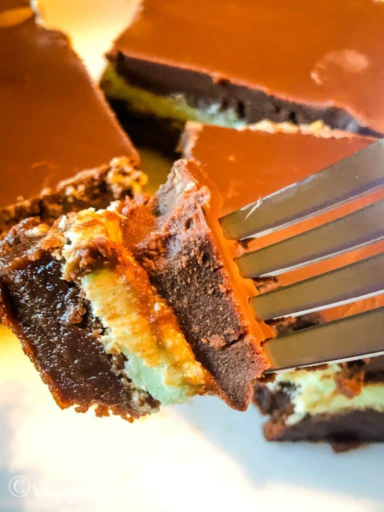 Chocolate mint brownies on a plate with a piece on a fork