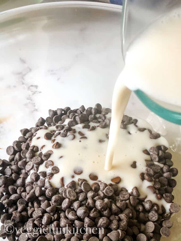 hot coconut cream pouring over chocolate chips