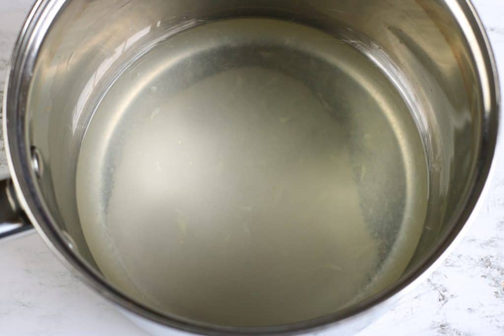metal sauce pan with simple syrup and lemon juice