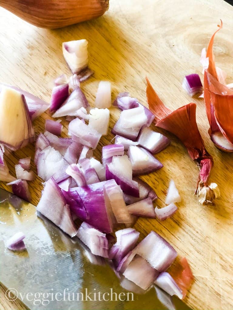 shallots being chopped on cutting board