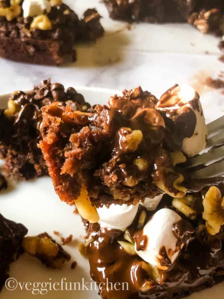 rocky road brownie on a fork with more pieces in background