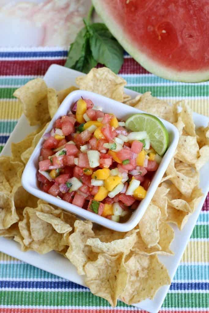 watermelon mango salsa in white bowl with chips