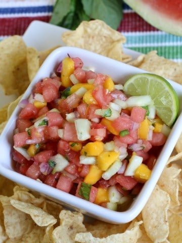 watermelon mango salsa in white bowl with chips