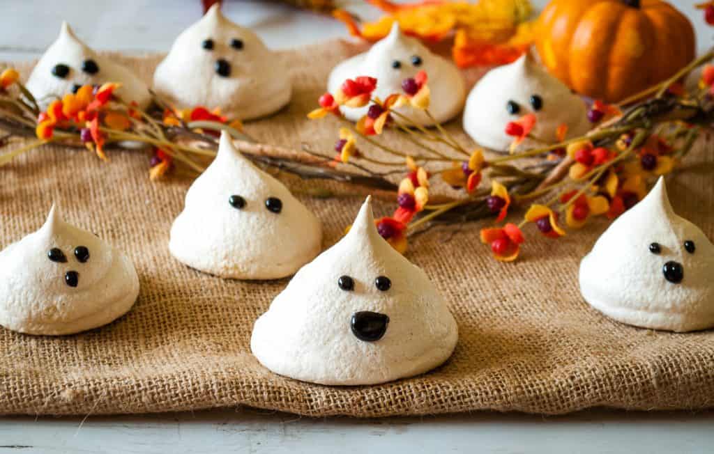 decorated ghostly vegan meringues on burlap