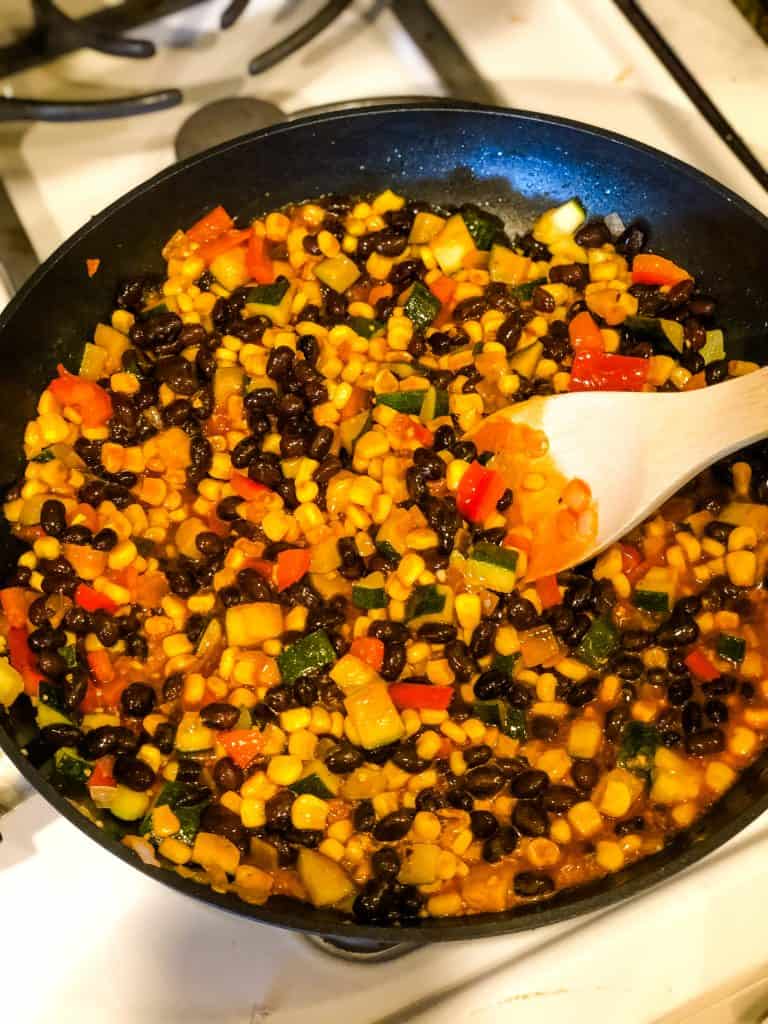 black beans and veggies sauteing in pan