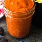 bourbon bbq sauce in glass jar with figs in foreground
