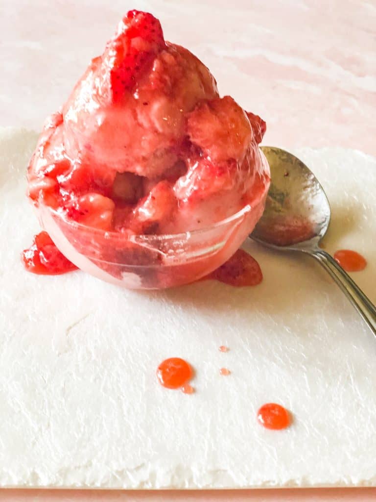 strawberry banana smoothie frozen into ice cream with strawberry topping