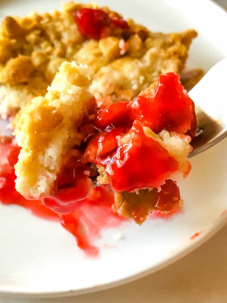 a forkful of delicious cherry cheesecake dump cake