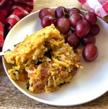 hash brown casserole on plate with grapes