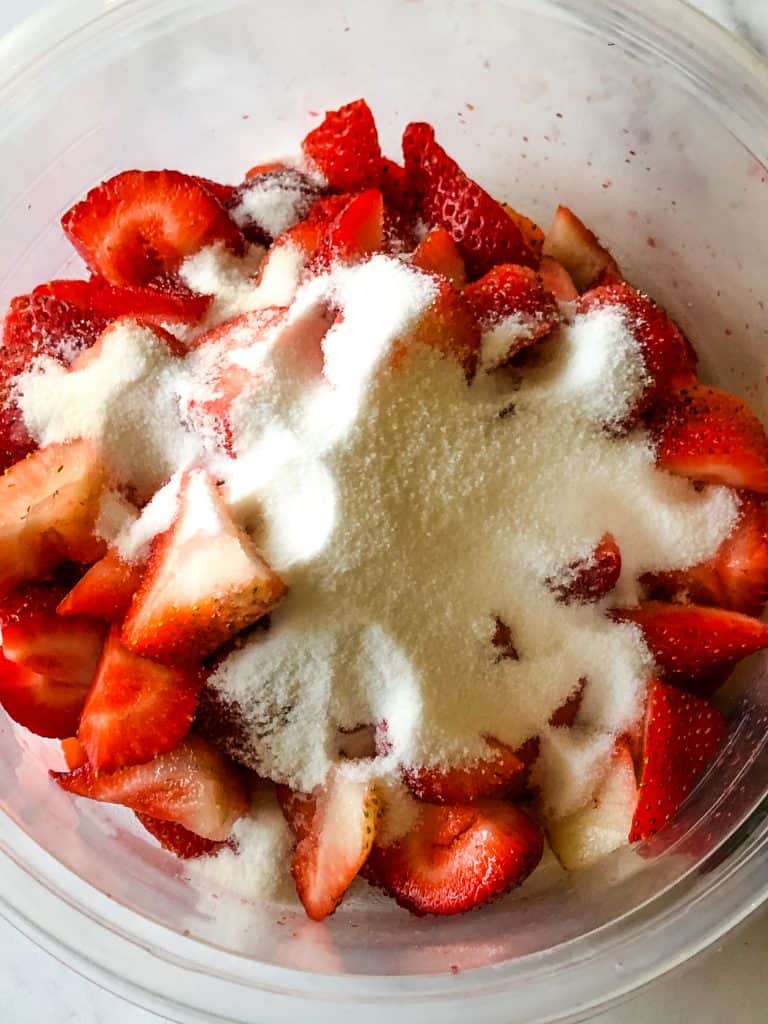 sugar on top of cut strawberries