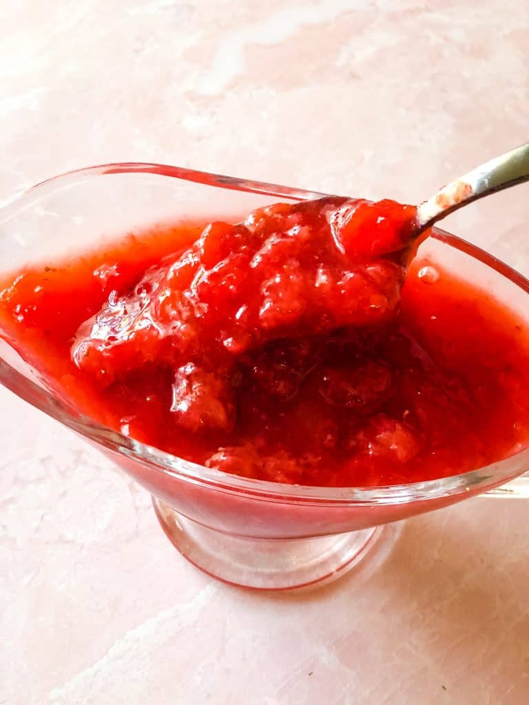 spooning out a delicious spoonful of strawberry topping