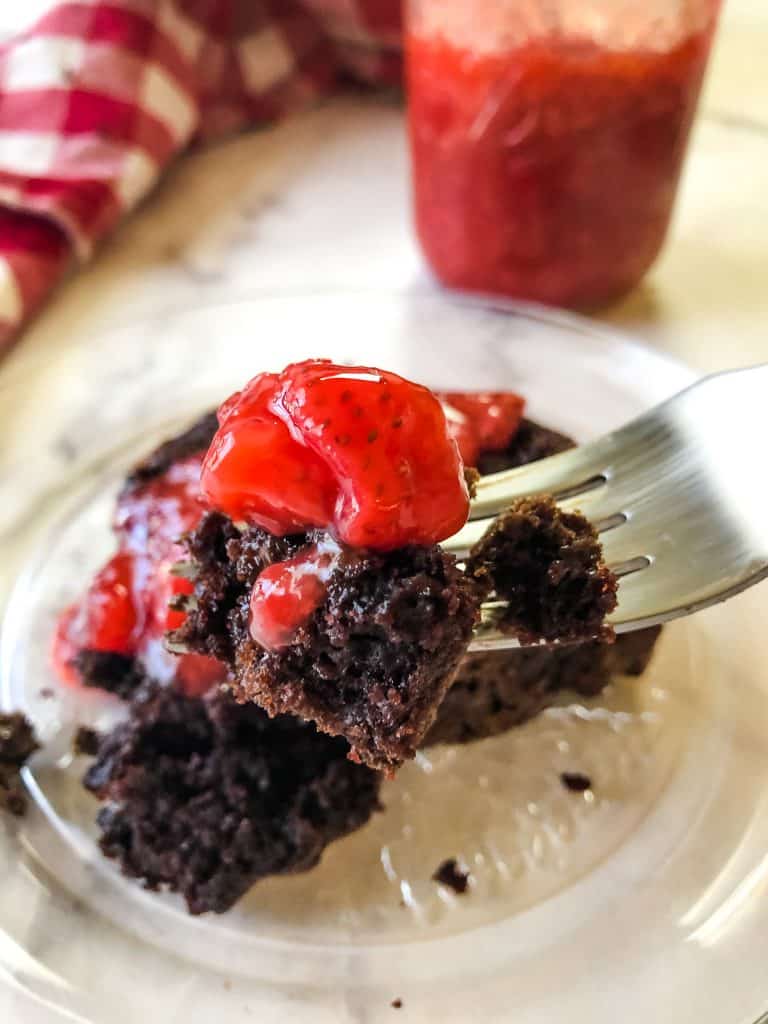 bite shot of devils food cake with strawberry topping
