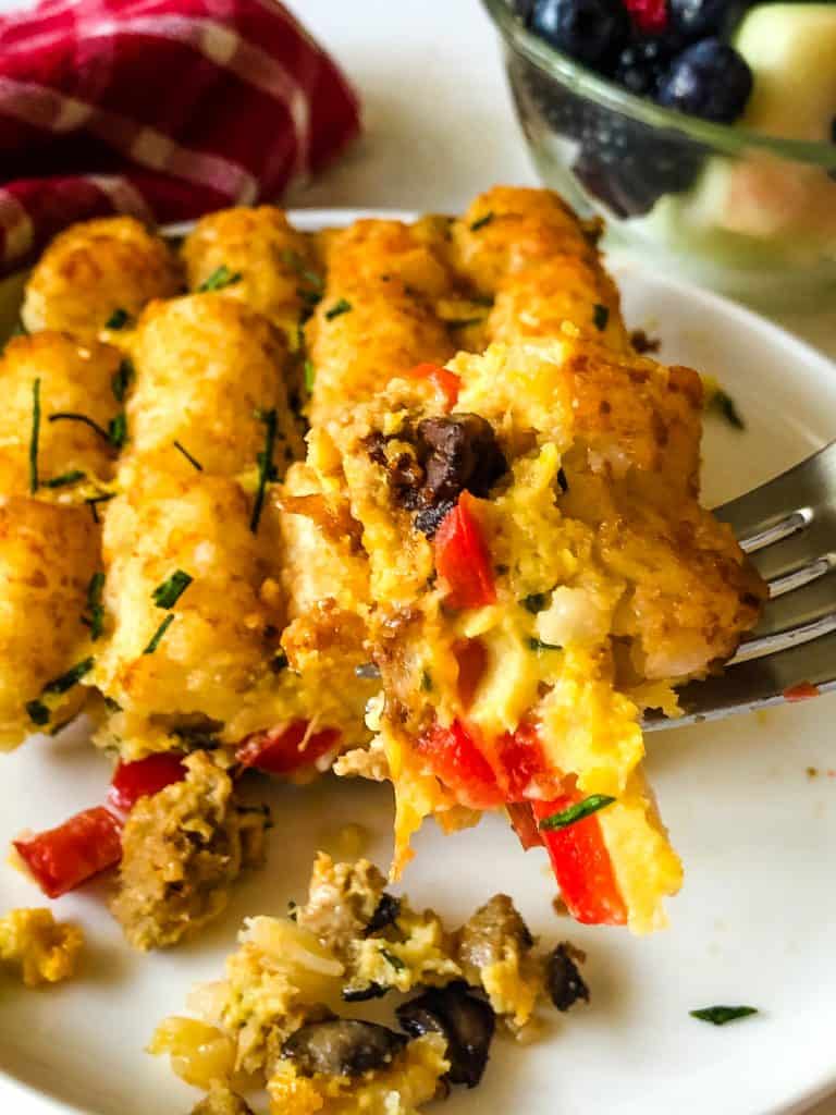 tater tot breakfast casserole with bowl of fruit