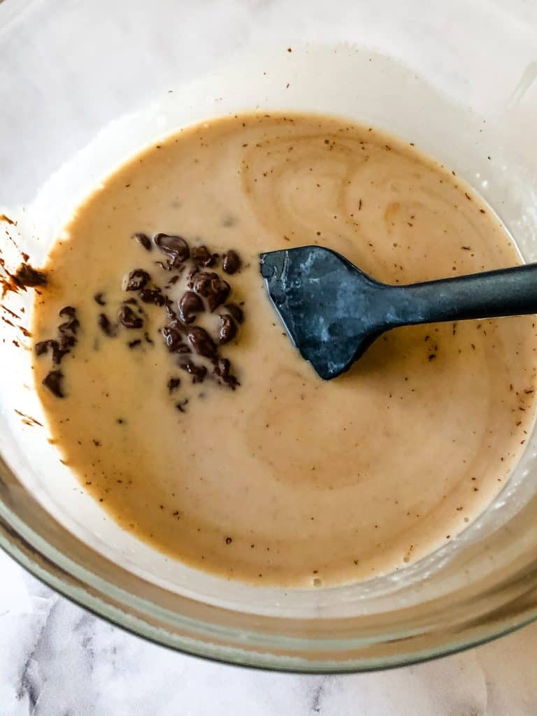 staring the melted chocolate into the hot coconut cream - the chocolate chips are not yet melted