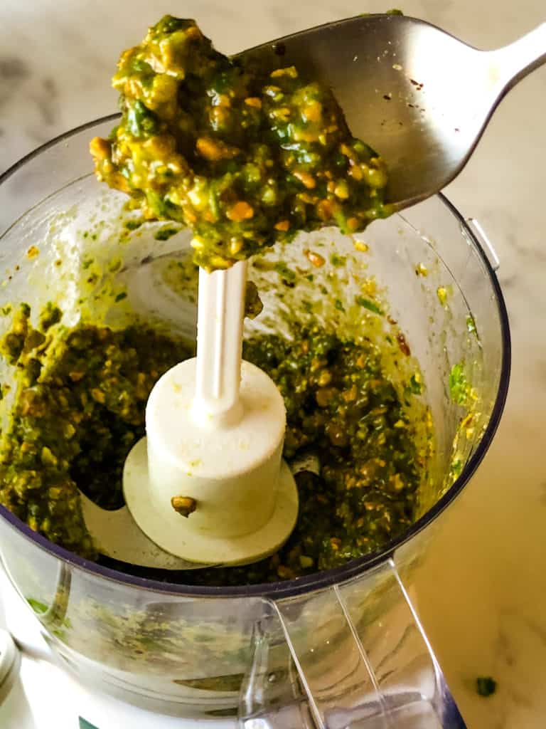 a spoonful of pistachio pesto from the food processor