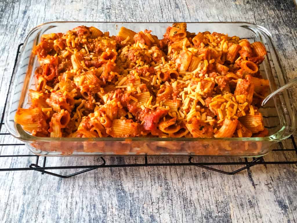 pasta bake in a glass casserole dish ready to serve