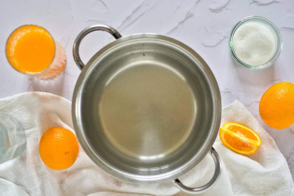 ingredients to make fresh orange sorbet including water, sugar, and fresh orange juice