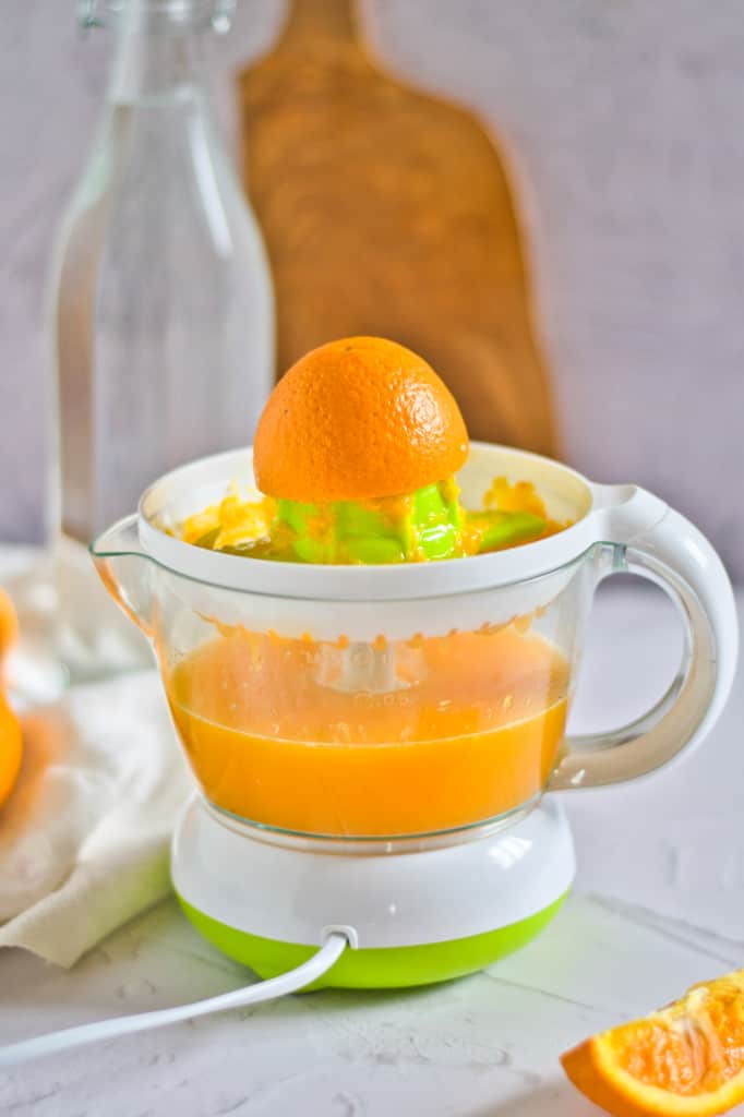 juicing the oranges in a citrus juicer