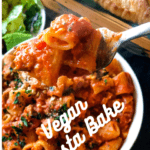 Vegan pasta bake in a dish with salad and bread in the background with pinterest text overlay