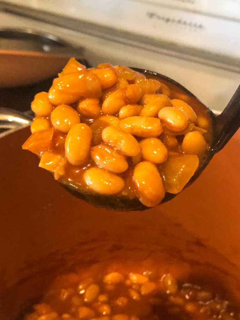 finished baked beans in a ladle