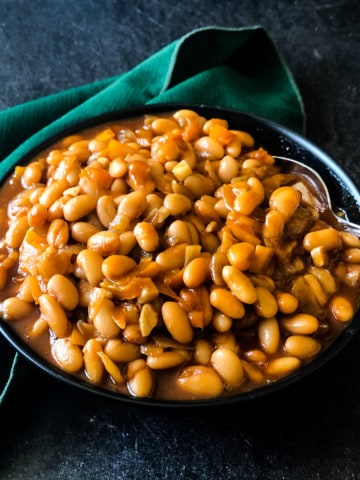 bourbon baked beans in a black bowl