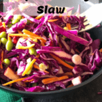 Purple cabbage slaw in black bowl with fork with pinterest text overlay